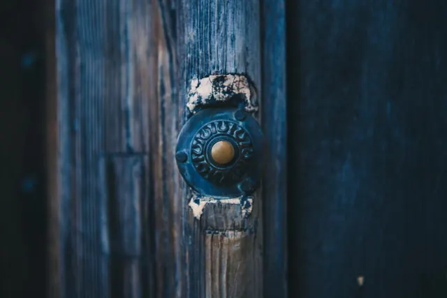 Blue wooden door with a round lock