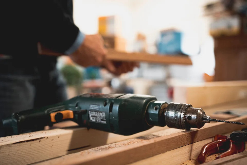 Drill resting on wooden boards during installation
