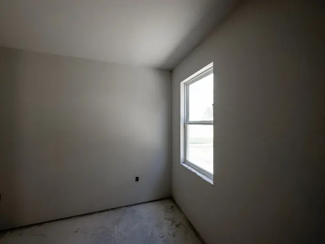 New room with finished walls and a window