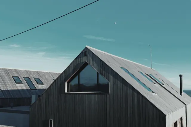 House clad in dark timber boards