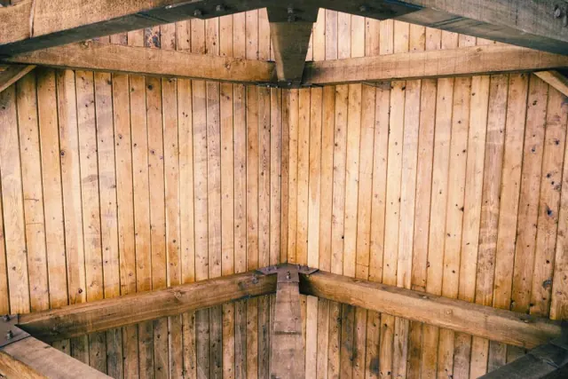 Wooden ceiling and wall panels meeting in a corner