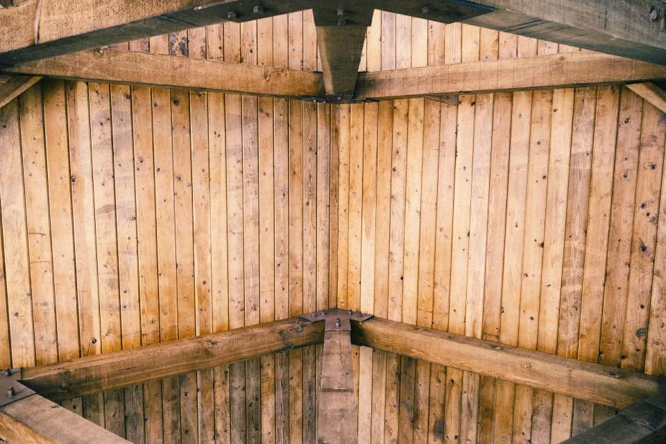Wooden ceiling and wall panels meeting in a corner